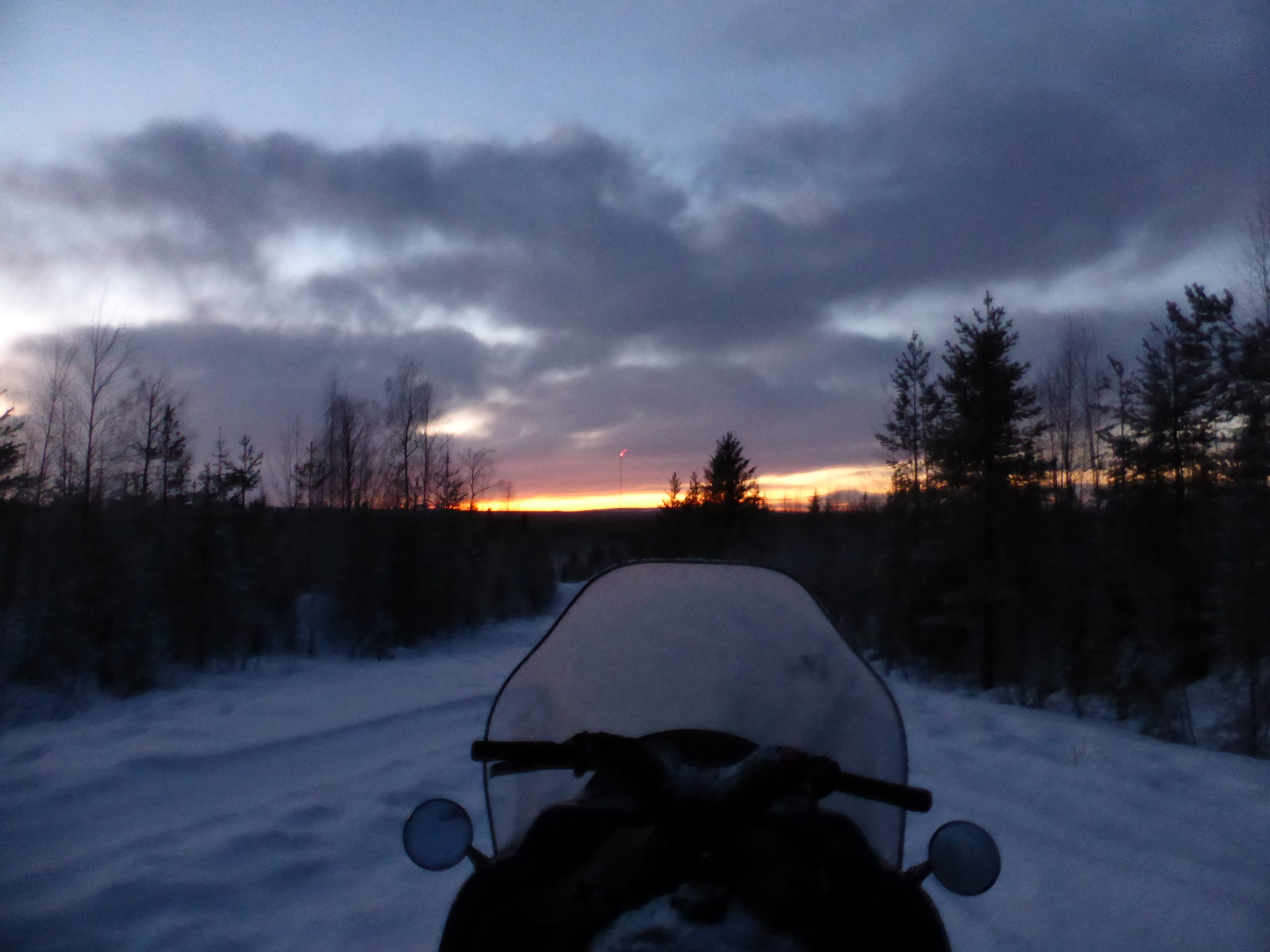 Snomobile at Sunset in Lapland Sweden