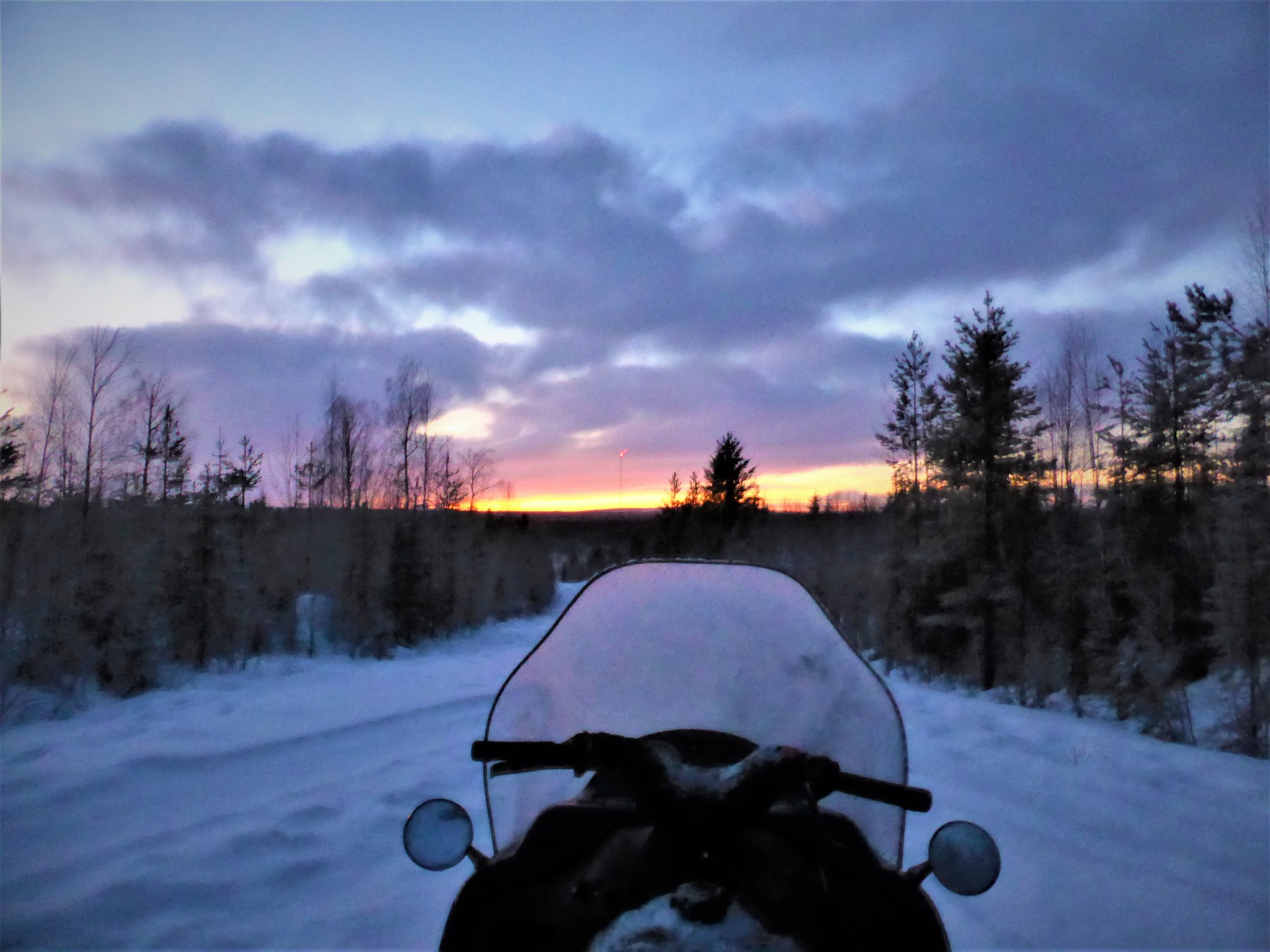 Snomobile at Sunset in Lapland Sweden by hesaidorshesaid