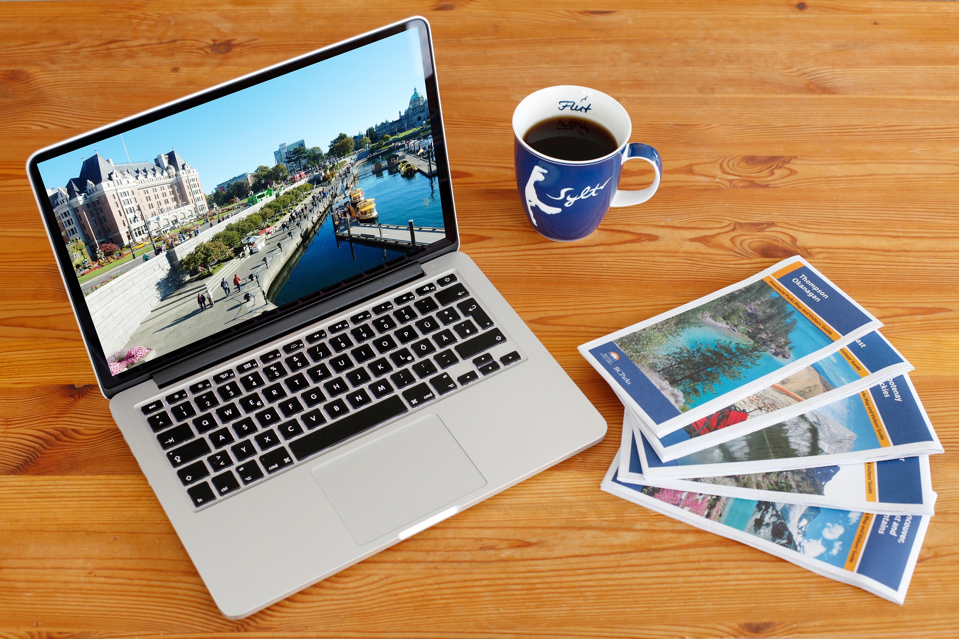 laptop coffee travel brochures