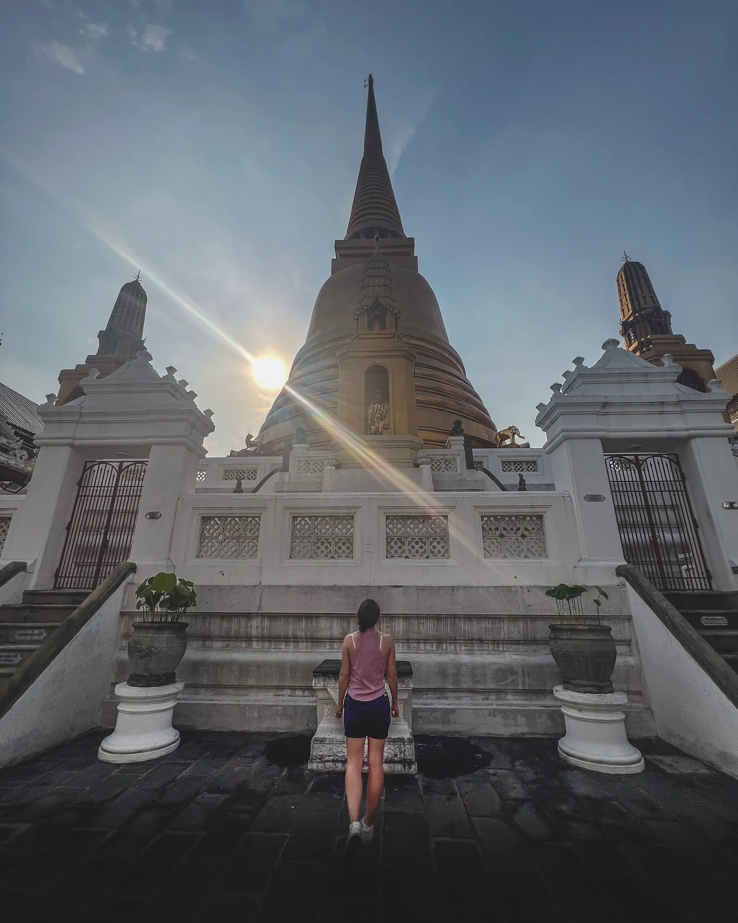 Woman walking toward a Thai Buddhist temple