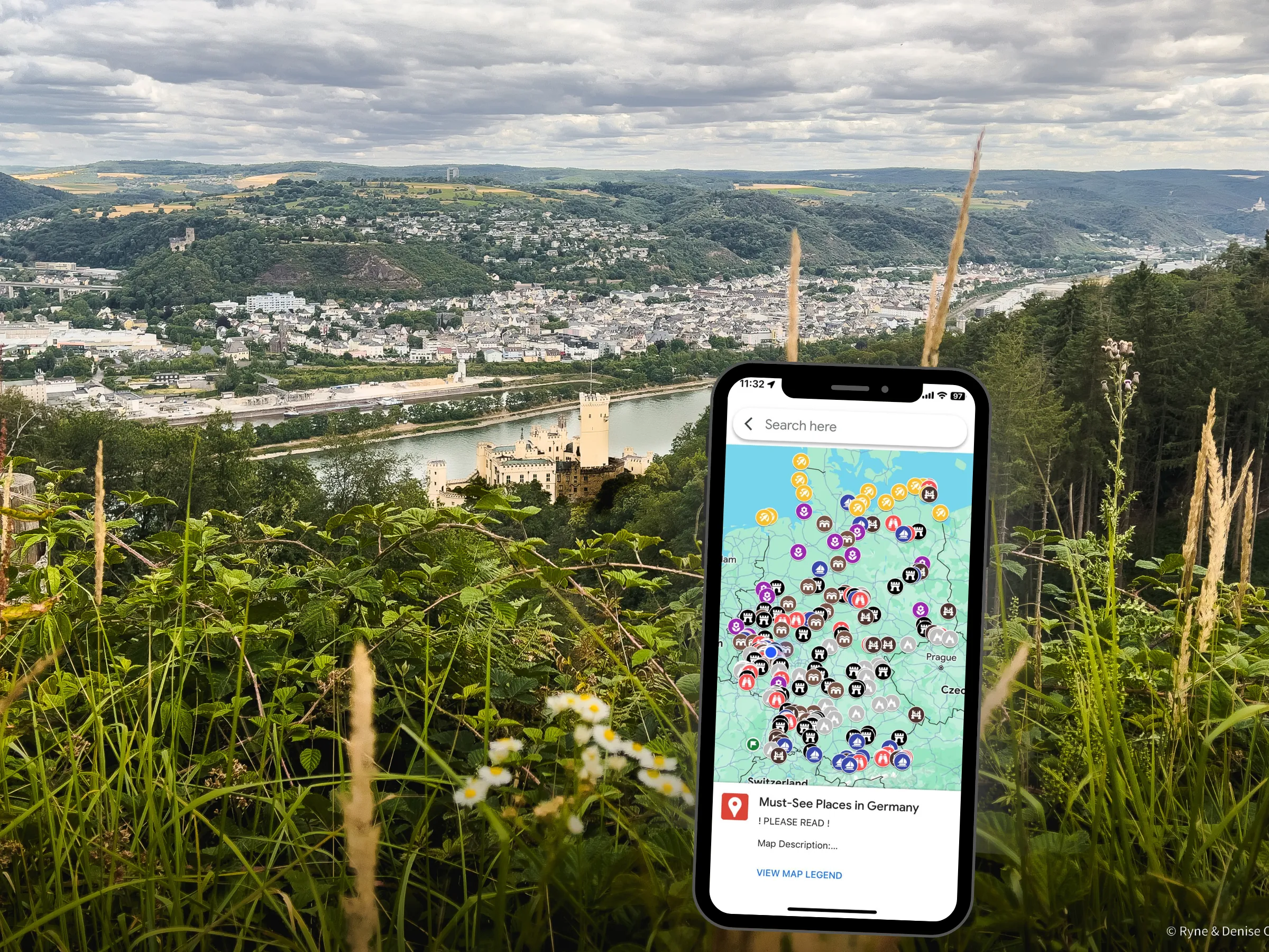 Castle surrounded by forest and river. Phone with custom map open in foreground.