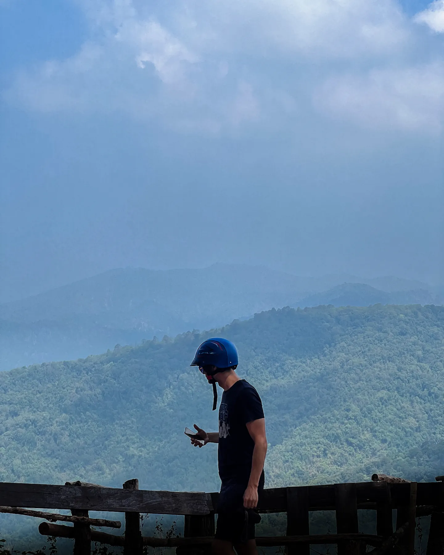 Man with scooter helmet at scenic view point in Thailand