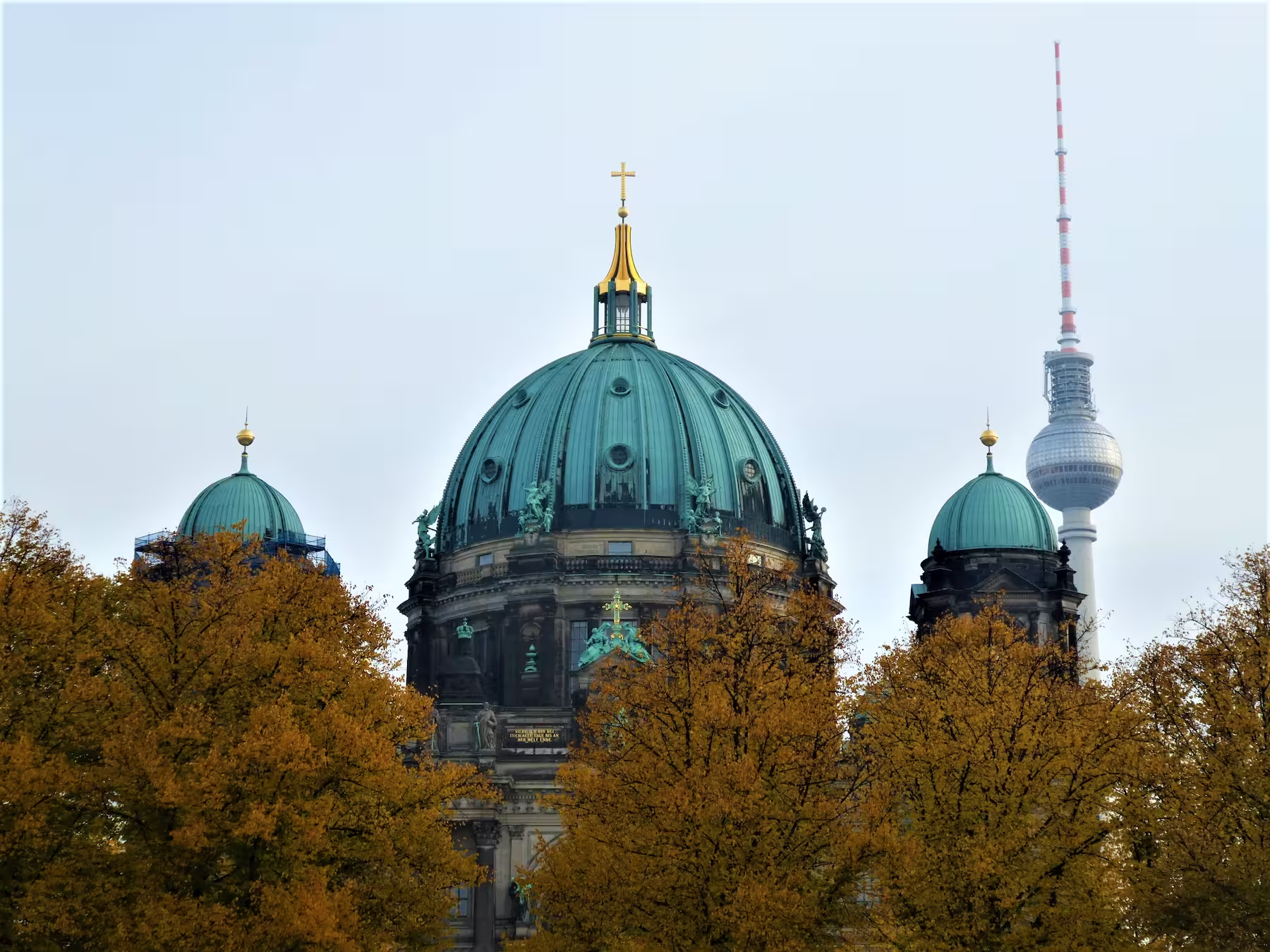 Berlin cathedral with tv tower in background during the fall