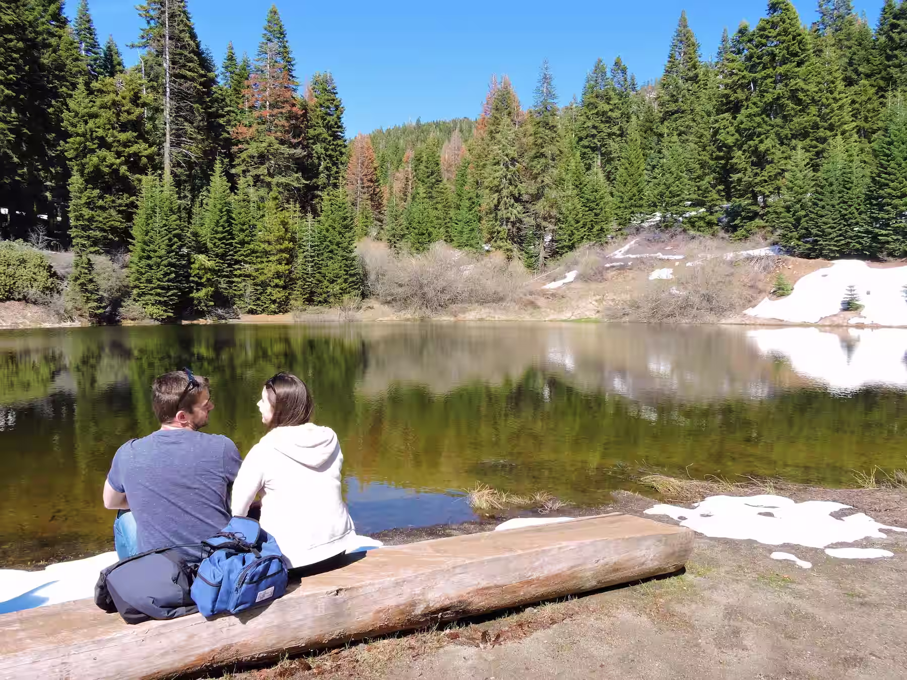 Ryne & Denise sitting at a lake near Sequoia Crest