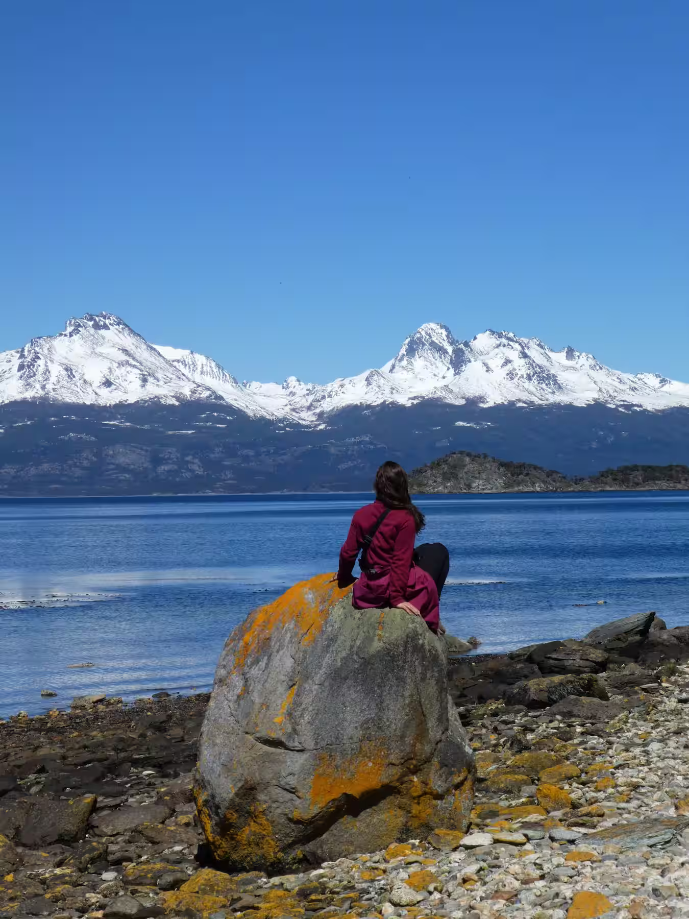 Denise sitting on a boulder in Tierra del Fuego National Park near Ushuaia