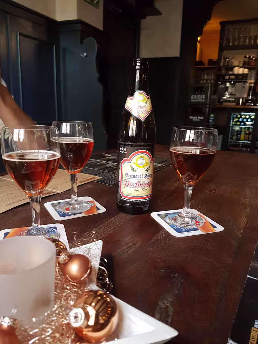 3 glasses of smoked beer on a table with Christmas decorations